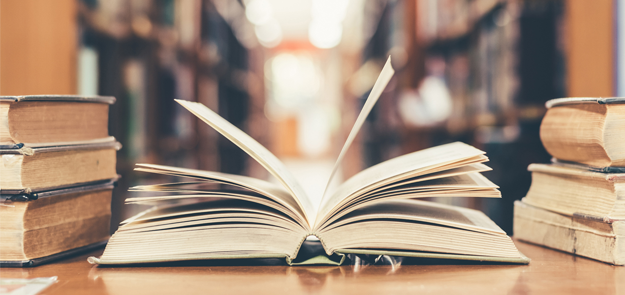 An open book on a table in a library.